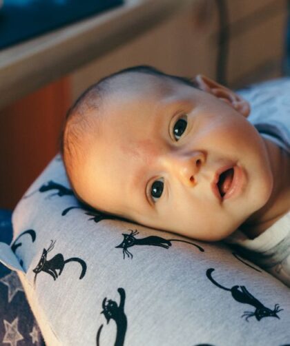 Charming infant captured tenderly indoors, showcasing innocence and warmth.