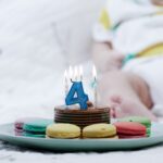 a plate of cookies with a birthday candle on it
