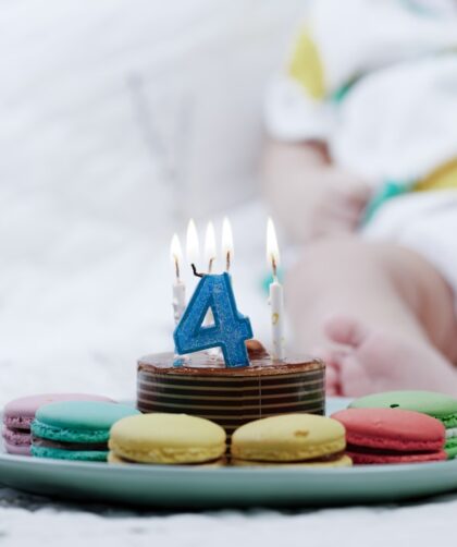 a plate of cookies with a birthday candle on it